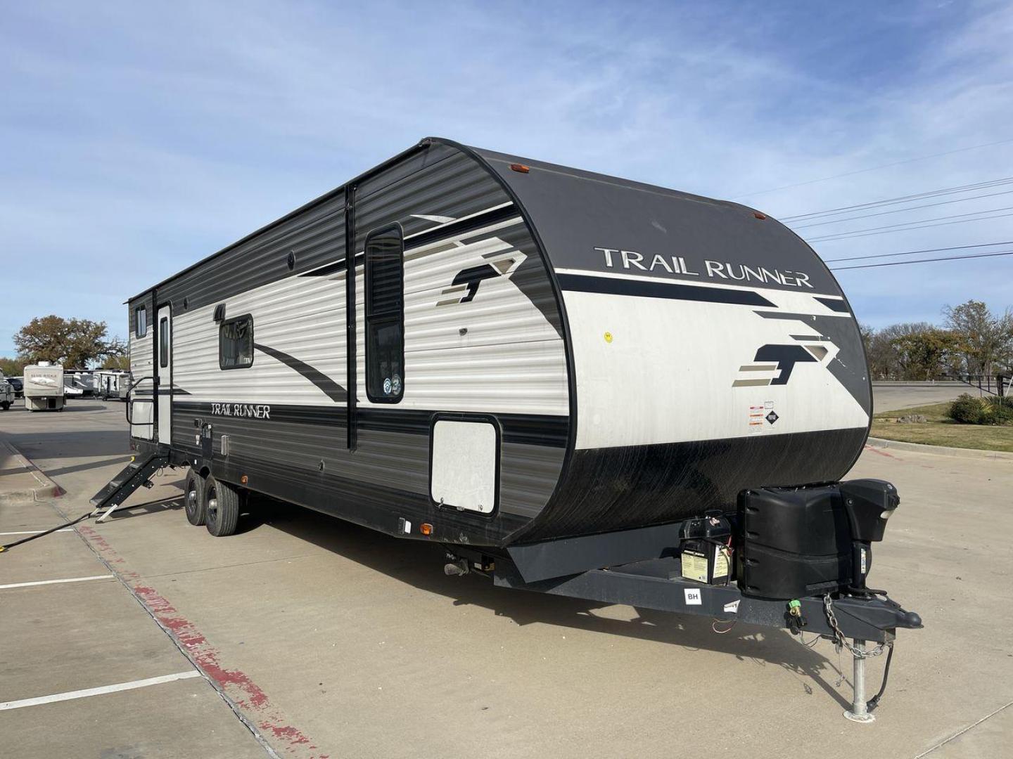 2022 HEARTLAND TRAIL RUNNER 31DB (5SFEB372XNE) , Length: 36.92 ft. | Dry Weight: 7,040 lbs. | Gross Weight: 9,642 lbs. | Slides: 1 transmission, located at 4319 N Main Street, Cleburne, TX, 76033, (817) 221-0660, 32.435829, -97.384178 - The 2022 Heartland Trail Runner 31DB has a robust and functional exterior design with modern accents. The front cap of the RV is curved for better aerodynamics, with the bold Trail Runner logo prominently displayed. The front also features a black diamond-plate guard, which offers protection from de - Photo#23