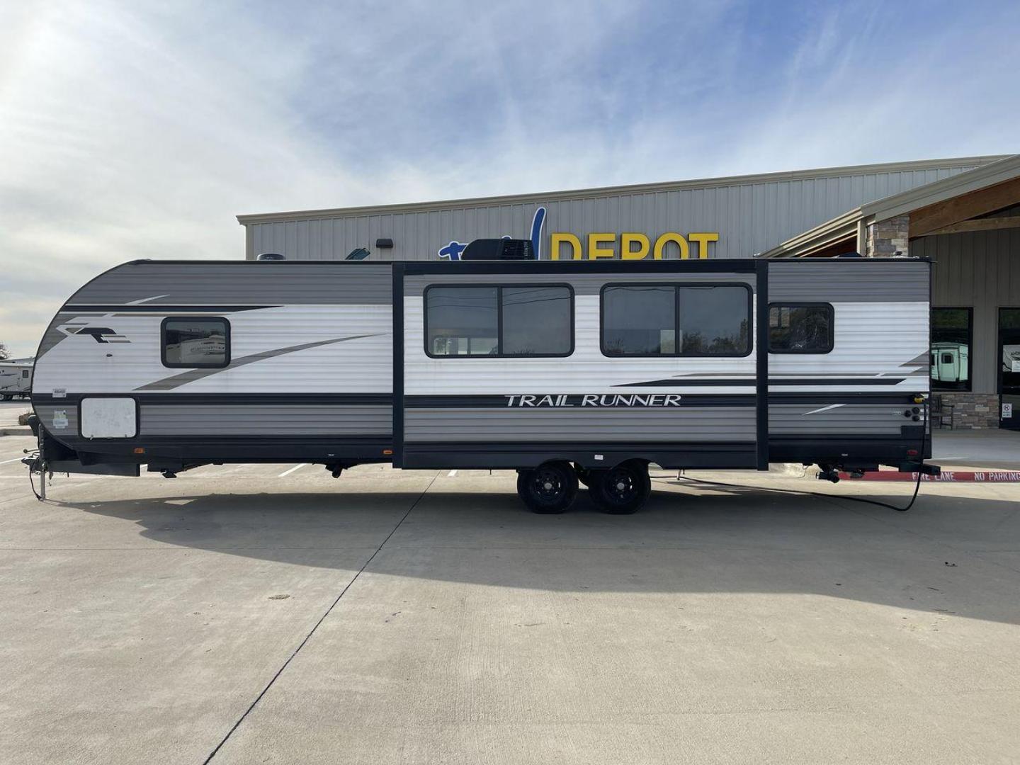 2022 HEARTLAND TRAIL RUNNER 31DB (5SFEB372XNE) , Length: 36.92 ft. | Dry Weight: 7,040 lbs. | Gross Weight: 9,642 lbs. | Slides: 1 transmission, located at 4319 N Main Street, Cleburne, TX, 76033, (817) 221-0660, 32.435829, -97.384178 - The 2022 Heartland Trail Runner 31DB has a robust and functional exterior design with modern accents. The front cap of the RV is curved for better aerodynamics, with the bold Trail Runner logo prominently displayed. The front also features a black diamond-plate guard, which offers protection from de - Photo#24