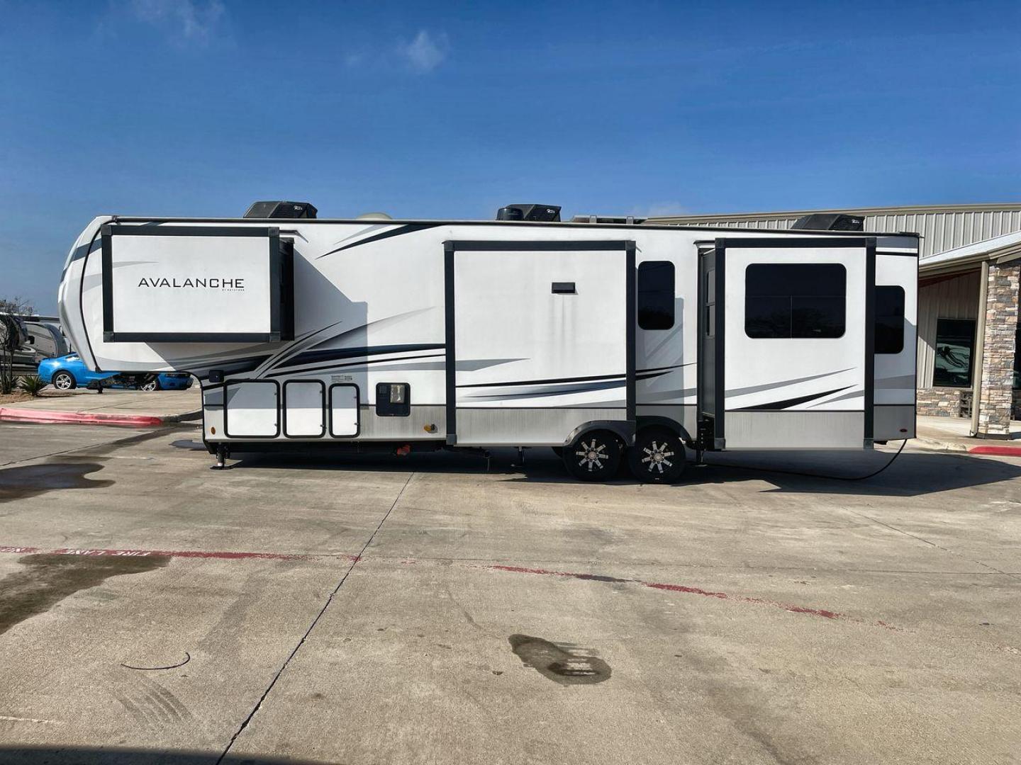 2022 KEYSTONE AVALANCHE 338GK (4YDFAVS24NE) , Length: 38 ft | Dry Weight: 12,523 lbs | Gross Weight: 15,500 lbs | Slides: 4 transmission, located at 4319 N Main Street, Cleburne, TX, 76033, (817) 221-0660, 32.435829, -97.384178 - The 2022 Keystone Avalanche 338GK showcases a sleek and modern exterior design, built for durability and style. This fifth wheel features a glossy white body accented by sharp, aerodynamic lines in subtle shades of gray and black, giving it a clean and contemporary look. The front cap is bold and ae - Photo#24