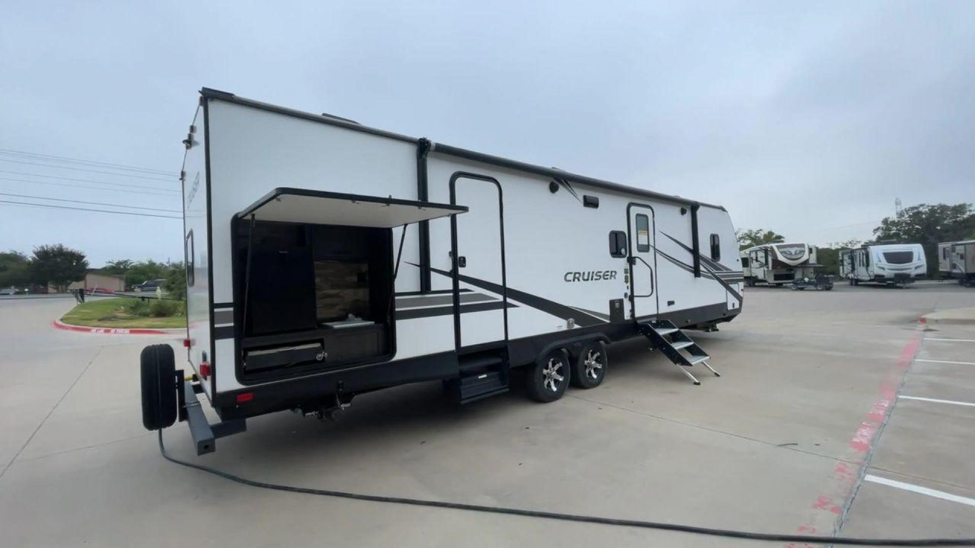 2022 KEYSTONE CRUISER 33BHB (4YDTCRS28N6) , Length: 37.83 ft. | Dry Weight: 7,832 lbs. | Slides: 2 transmission, located at 4319 N Main Street, Cleburne, TX, 76033, (817) 221-0660, 32.435829, -97.384178 - The 2022 Keystone Cruiser 33BHB has a sleek, modern exterior design. The front showcases a rounded, aerodynamic front cap with the Cruiser Aire branding prominently displayed. The body of the RV is predominantly white, accented with stylish black and gray graphic designs that add a sharp, streamline - Photo#1