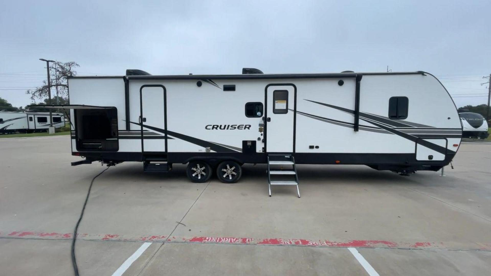 2022 KEYSTONE CRUISER 33BHB (4YDTCRS28N6) , Length: 37.83 ft. | Dry Weight: 7,832 lbs. | Slides: 2 transmission, located at 4319 N Main Street, Cleburne, TX, 76033, (817) 221-0660, 32.435829, -97.384178 - The 2022 Keystone Cruiser 33BHB has a sleek, modern exterior design. The front showcases a rounded, aerodynamic front cap with the Cruiser Aire branding prominently displayed. The body of the RV is predominantly white, accented with stylish black and gray graphic designs that add a sharp, streamline - Photo#2