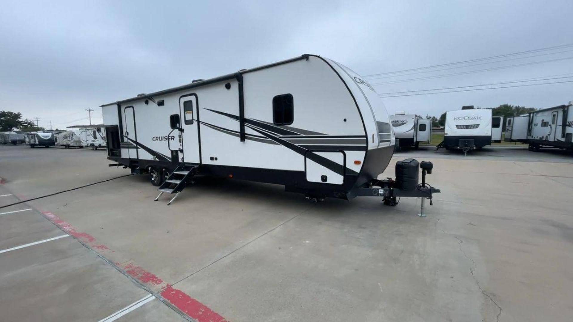 2022 KEYSTONE CRUISER 33BHB (4YDTCRS28N6) , Length: 37.83 ft. | Dry Weight: 7,832 lbs. | Slides: 2 transmission, located at 4319 N Main Street, Cleburne, TX, 76033, (817) 221-0660, 32.435829, -97.384178 - The 2022 Keystone Cruiser 33BHB has a sleek, modern exterior design. The front showcases a rounded, aerodynamic front cap with the Cruiser Aire branding prominently displayed. The body of the RV is predominantly white, accented with stylish black and gray graphic designs that add a sharp, streamline - Photo#3