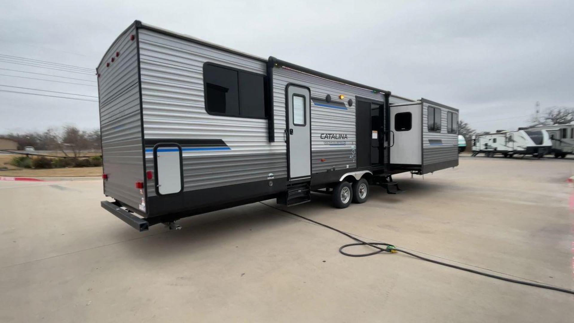 2023 COACHMEN CATALINA 39MKTS (5ZT2CA4B8PX) , Length: 40.92 ft | Dry Weight: 9,409 lbs | Gross Weight: 11,000 lbs | Slides: 3 transmission, located at 4319 N Main Street, Cleburne, TX, 76033, (817) 221-0660, 32.435829, -97.384178 - The Coachmen Catalina 39MKTS (Destination Series) RV has a sleek and modern exterior, designed for comfort and durability. At 40.92 ft long, its high-quality aluminum siding is accented with bold blue and black graphics, giving it a striking look that stands out in any RV park or campground. The dua - Photo#1