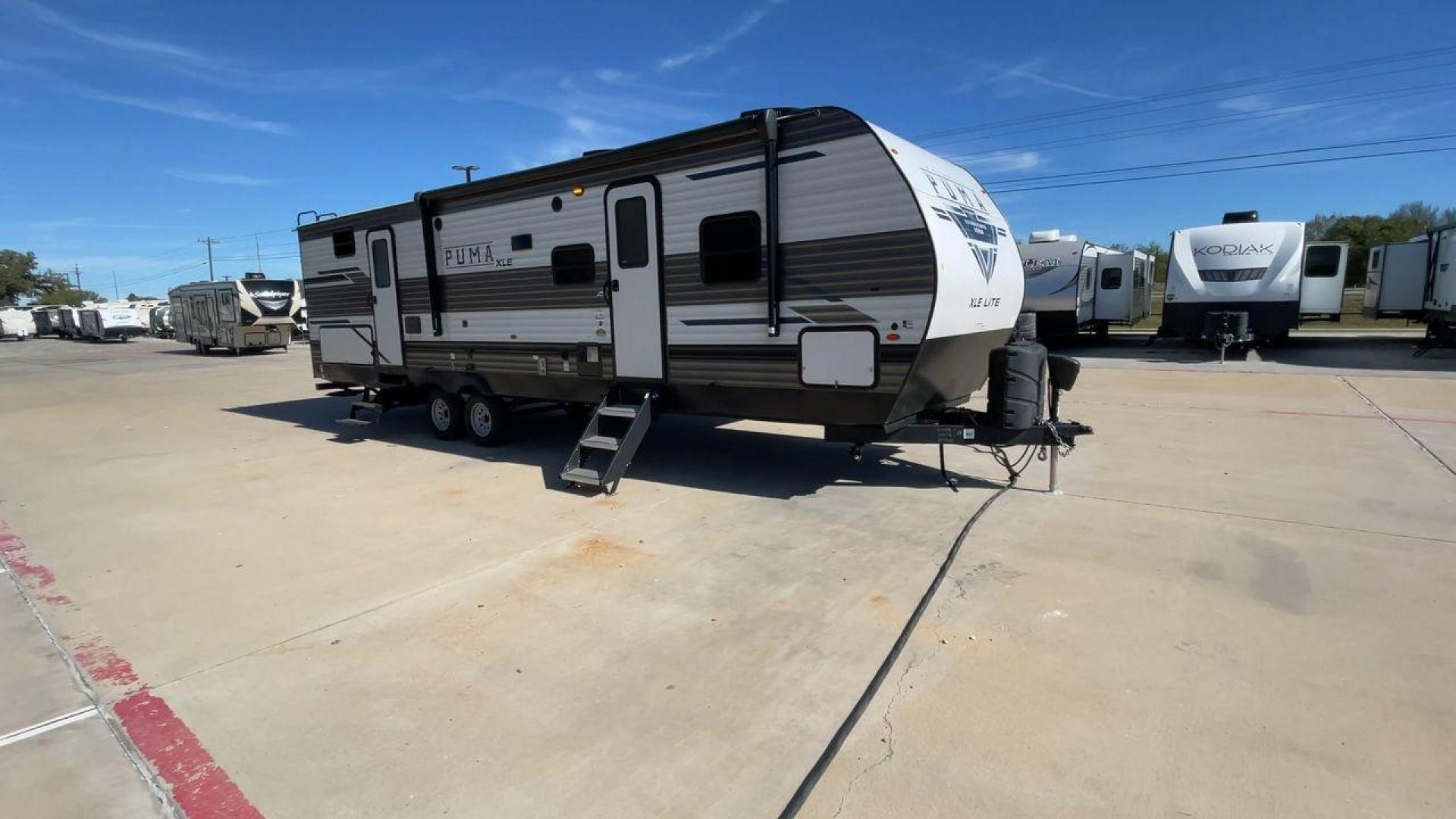 2023 FOREST RIVER PUMA 31BHSC (5ZT2PUWB4P4) , Length: 35.5 ft. | Dry Weight: 7,946 lbs. | Gross Weight: 9,600 lbs. | Slides: 2 transmission, located at 4319 N Main Street, Cleburne, TX, 76033, (817) 221-0660, 32.435829, -97.384178 - The 2023 Palomino Puma 31BHSC stands out with its sleek and modern exterior design. Measuring 35.5 feet in length, this unit is built for comfort and style. Its aluminum siding features a striking two-tone finish. With two large slide-outs, this RV offers expanded living space when parked. The front - Photo#3