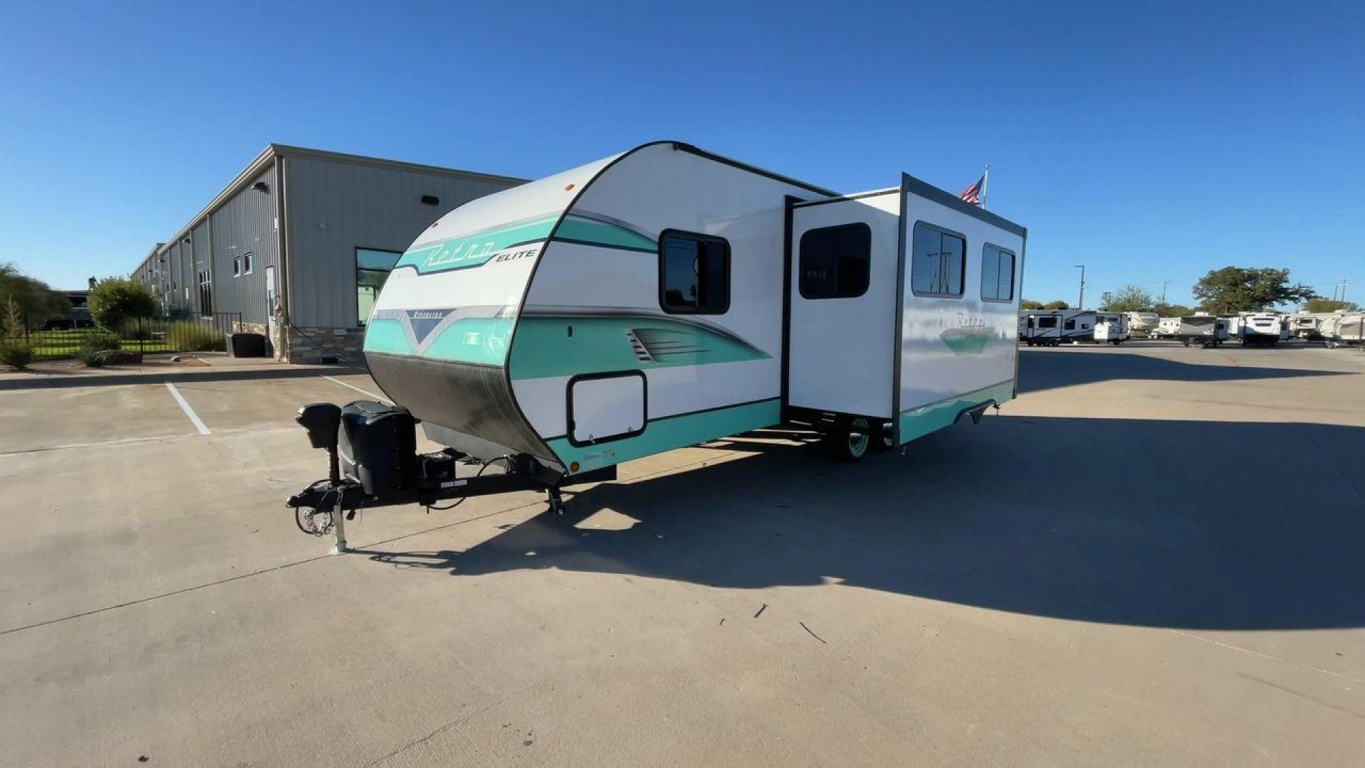 2023 RIVERSIDE RETRO 245RB (59CR42827PL) , Length: 24.92 ft. | Dry Weight: 4,720 lbs. | Slides: 1 transmission, located at 4319 N Main Street, Cleburne, TX, 76033, (817) 221-0660, 32.435829, -97.384178 - The 2023 Riverside Retro 245RB features a charming, vintage-inspired design. The exterior showcases a bright white body with soft turquoise accents, giving it a classic, nostalgic look. The Retro Elite branding is prominently displayed on the side, adding to the retro feel. The trailer has a smooth, - Photo#5