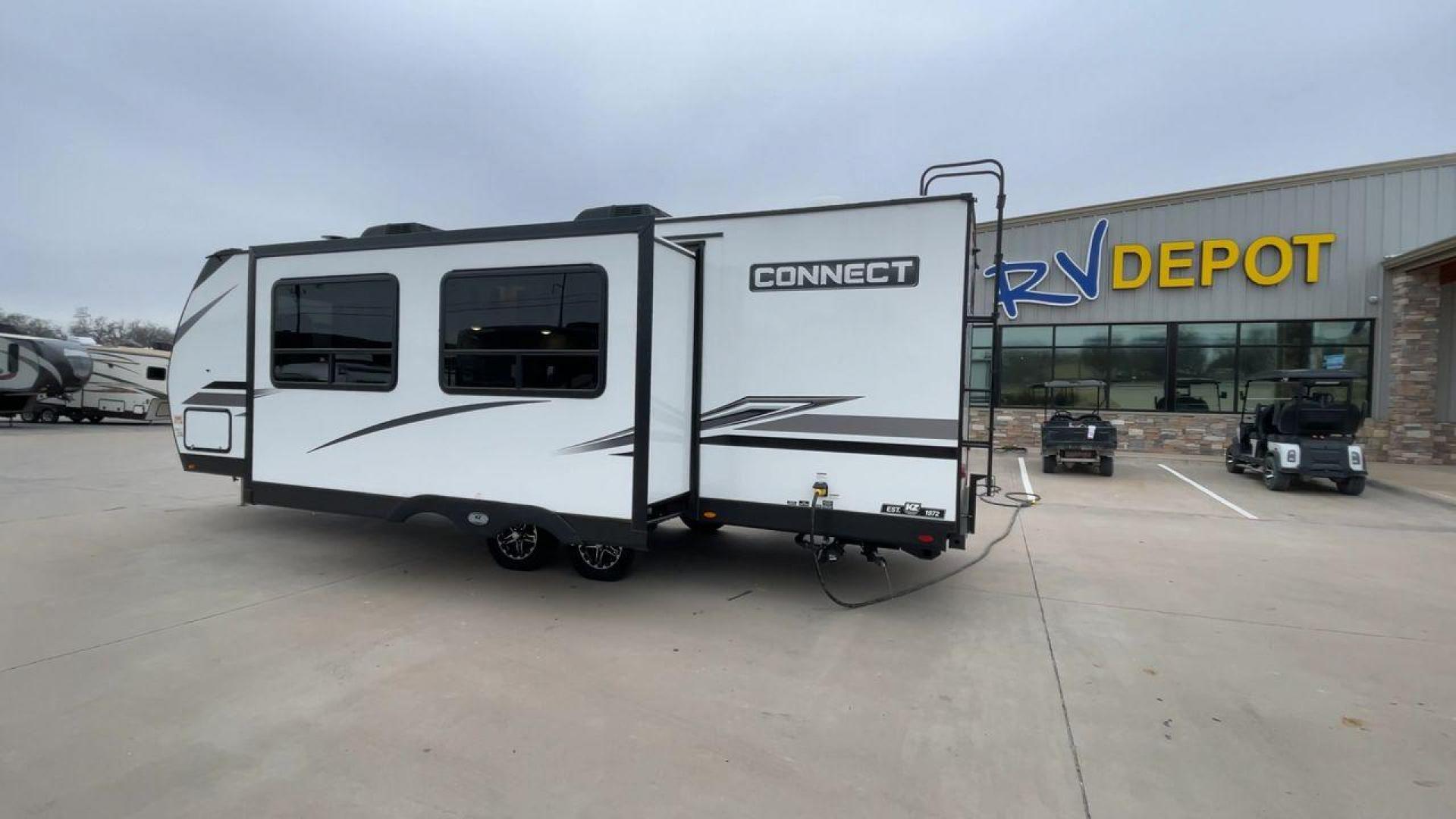 2024 KZ CONNECT 261RB (4EZTL2721R7) , Length: 30.33 ft | Dry Weight: 6,460 lbs | Gross Weight: 7,345 lbs | Slides: 1 transmission, located at 4319 N Main Street, Cleburne, TX, 76033, (817) 221-0660, 32.435829, -97.384178 - At 30.33 ft long, the 2024 KZ Connect 261RB is a modern and stylish travel trailer with a sleek and aerodynamic design. Its white fiberglass exterior is accented with black and gray geometric decals, giving it a sharp and contemporary look. The front cap is painted black with the CONNECT branding pr - Photo#7